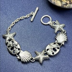Silver tone beach themed charm link toggle bracelet